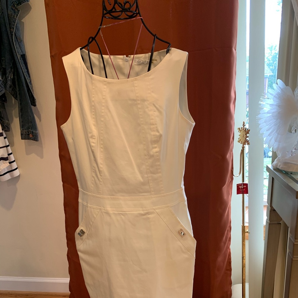 Slim fitting dress with gol trim, slit pockets,